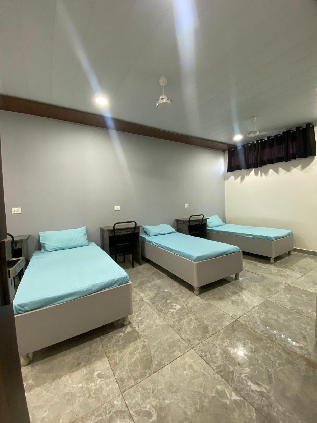 Spacious triple sharing room with new beds and AC