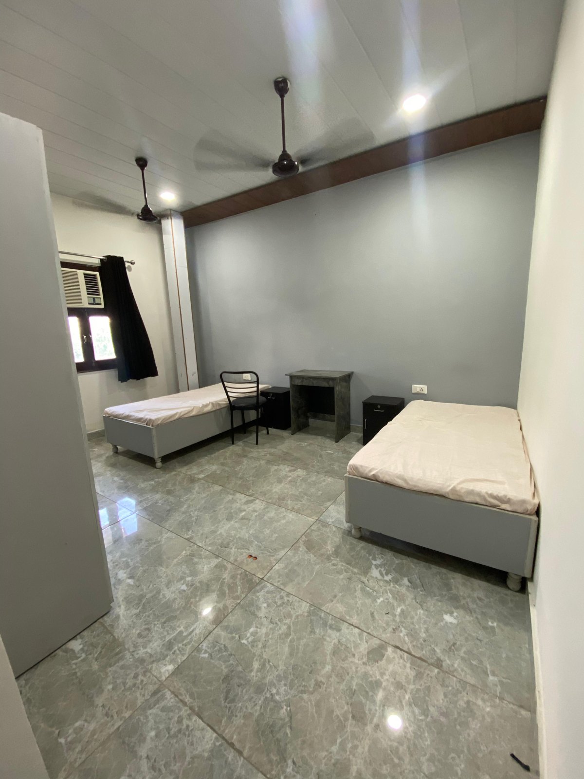 Spacious shared room with study desk and storage
