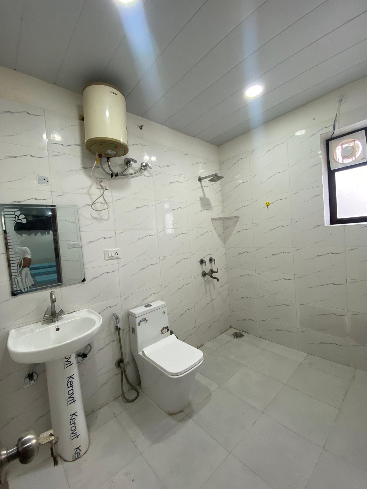 Clean attached washroom with geyser