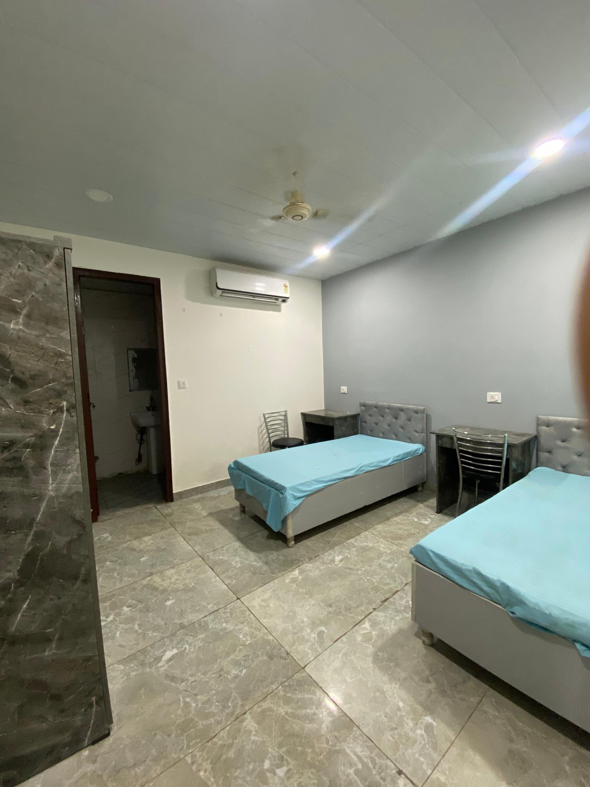Air-conditioned twin sharing room with marble flooring